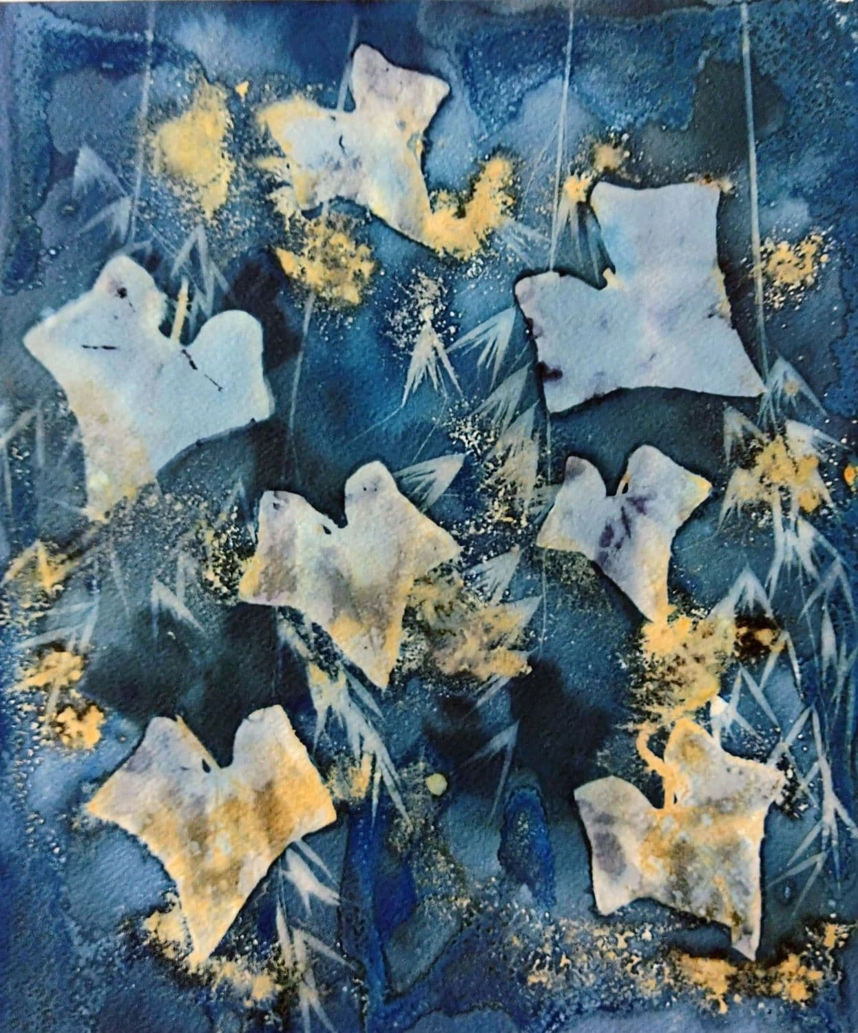 Cyanotype artwork by Matilde Canepa Gonzalez, displaying a deep Prussian blue background with light blue and white ivy leaves, delicate pointed grass structures, and elegant shimmering gold dust accents throughout.